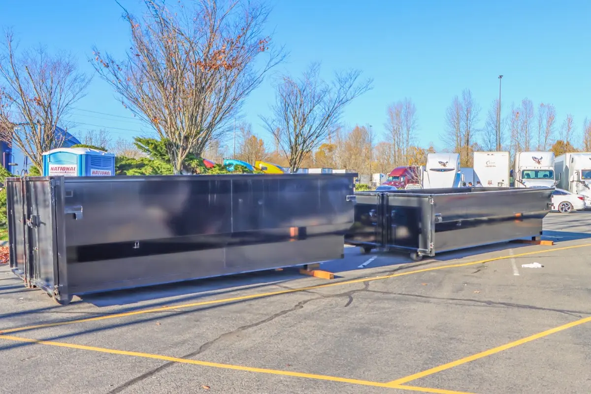 Professional dumpster rental service with roll-off container on residential driveway in Orono